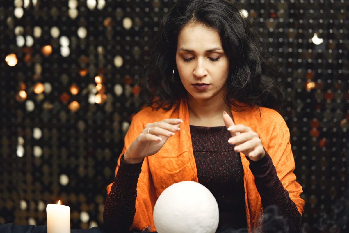 Portrait of fortune-teller in a dark room